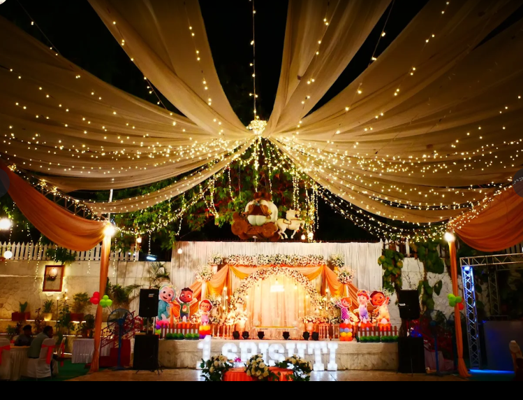 Orange draped stage decorated for a children's themed celebration