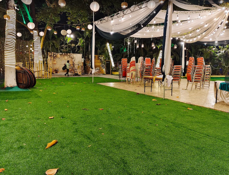 The open-air lawn at Blossoms Lawn set up with chairs and string lights before a celebration